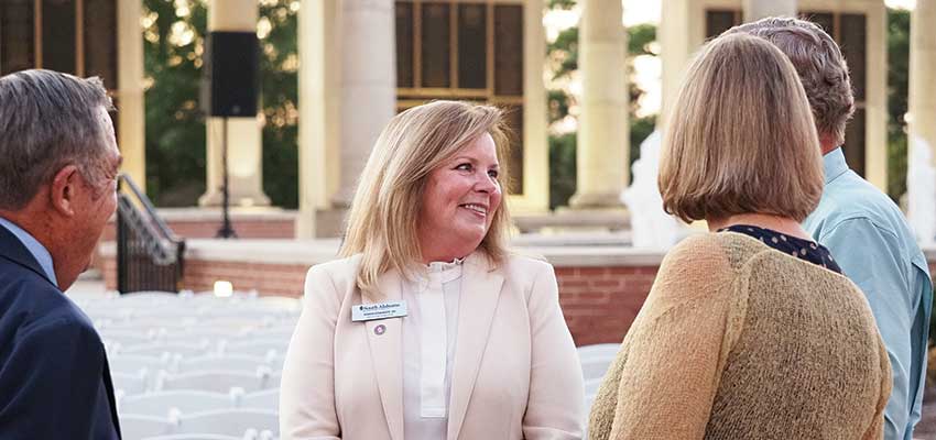 Karen Edwards and alumni at Moulton Tower.