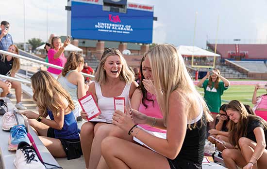 Sorority students on bid day at Hancock Whitney Stadium.