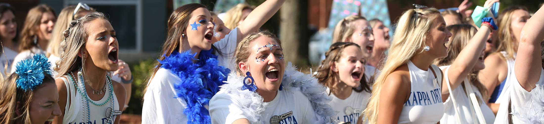 Kappa Delta Bid Day with sorority girls running out.