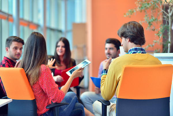 Group sitting in chairs in a circle in an office.