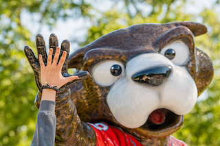 Student high fiving Southpaw