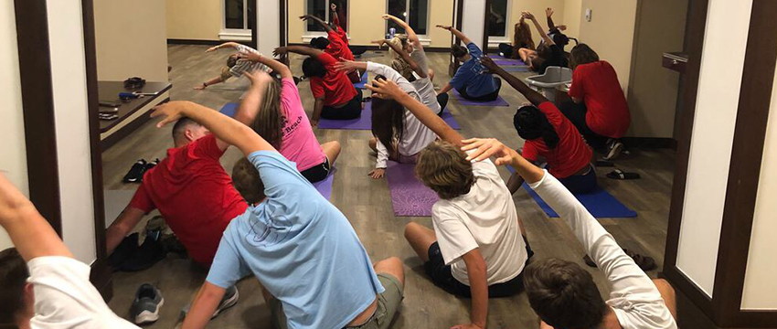 Students doing yoga in housing