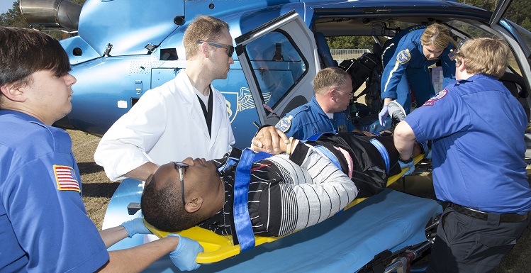 South students in the emergency medical services program load a "victim" onto a helicopter for treatment at a local hospital during an annual disaster drill held Thursday on campus.
