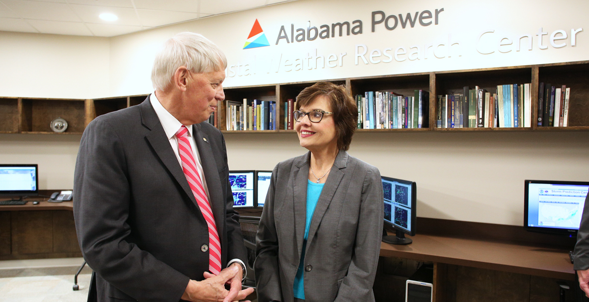 Dr. Tony Waldrop, University of South Alabama president, talks with Beth Thomas, corporate communications manager for Alabama Power, inside the new Alabama Power USA Coastal Weather Research Center. The center provides weather forecasting to more than 100 clients. 
