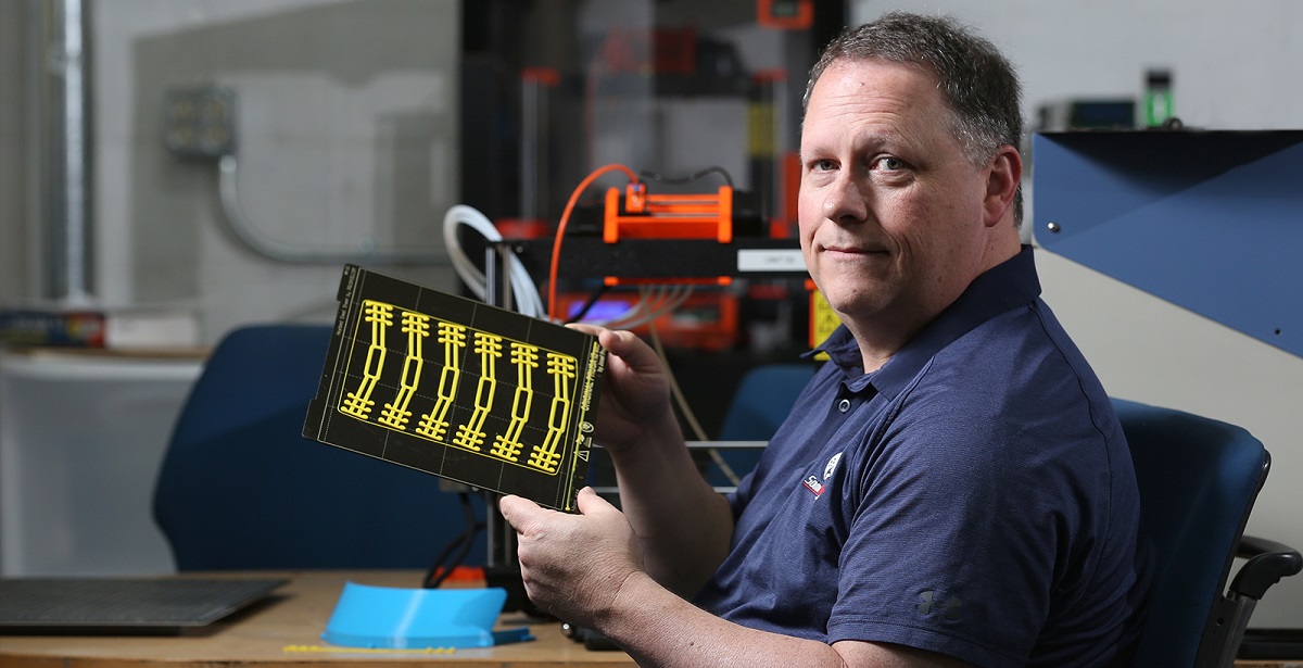 Ricky Green, an information technology instructor at the University of South Alabama, uses 3D printers to produce parts that will be put together to make face shields for healthcare workers. 