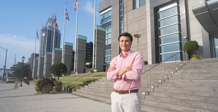 Gabriel Kucala standing in downtown Mobile. 