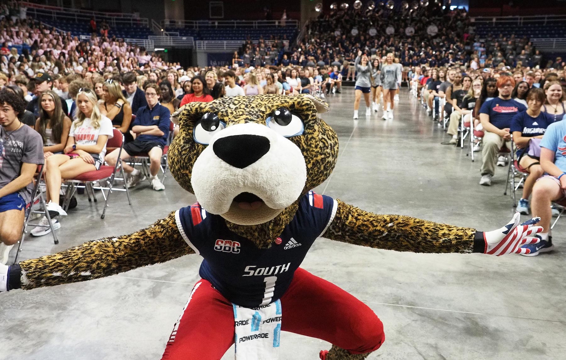 SouthPaw with first-year students at Convocation in the Mitchell Center. 