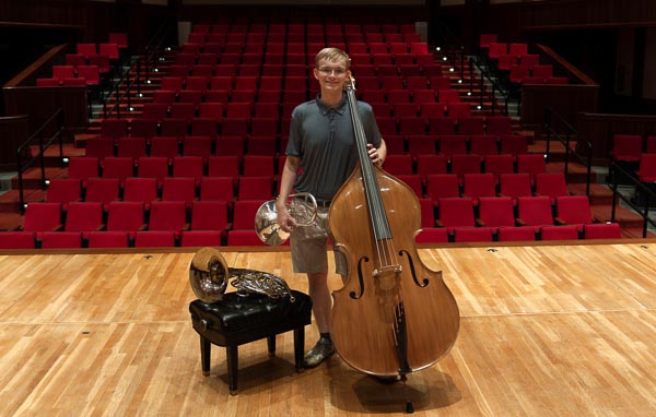 Noah Sugg, the 2024-25 University of South Alabama Board of Trustees Scholar, on the Laidlaw stage with the double bass, French horn, and mellophone.