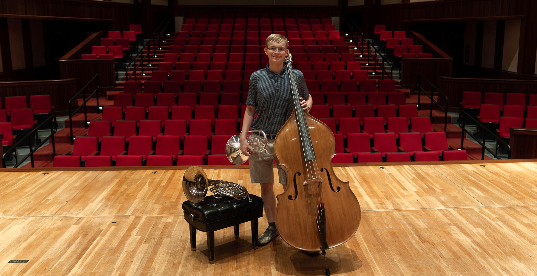 Noah Sugg, the 2024-25 University of South Alabama Board of Trustees Scholar, on the Laidlaw stage with the double bass, French horn, and mellophone.