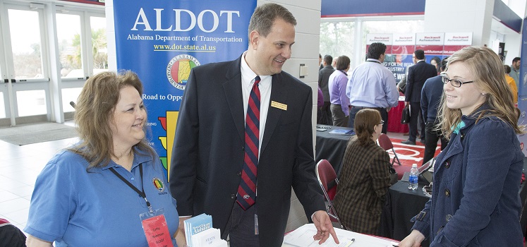 student speaking with two ALDOT representatives at career fair 