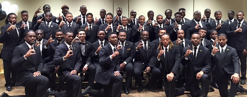 students pose for a picture in suits