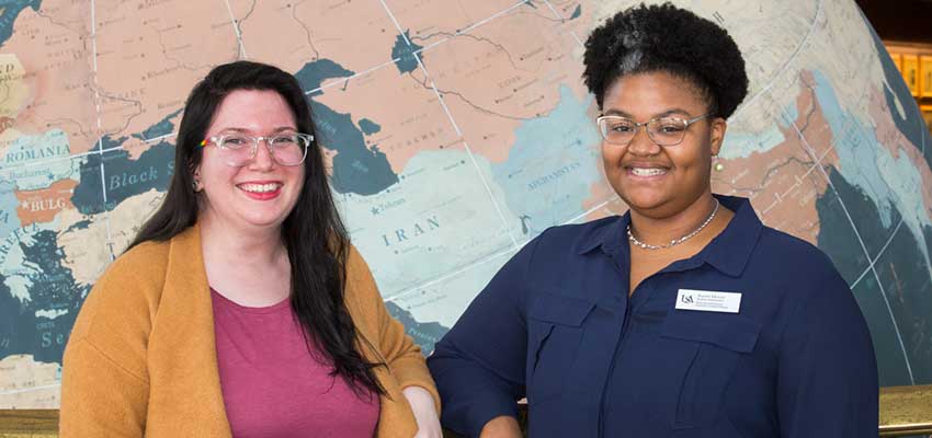 Shelby Merritt and Auriel Moore in front of map image.