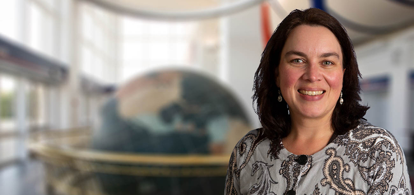 Christine Rinne standing in front of Waterman Globe