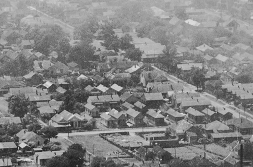 1922 aerial image showing dense housing along Our Alley between Texas and Elmira Streets. 