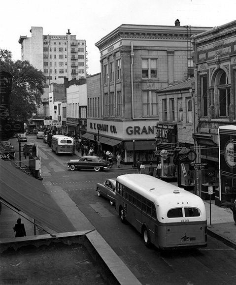 Black and white photo of a bus on a city street