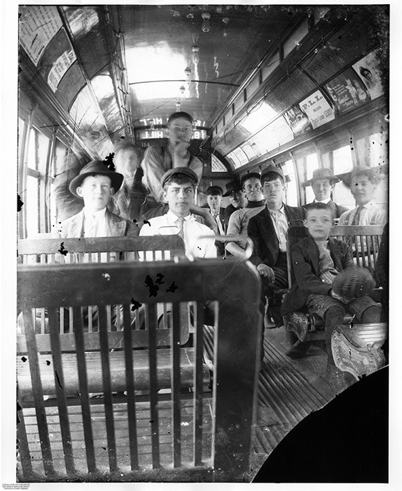 Black and white photo of passengers inside a streetcar